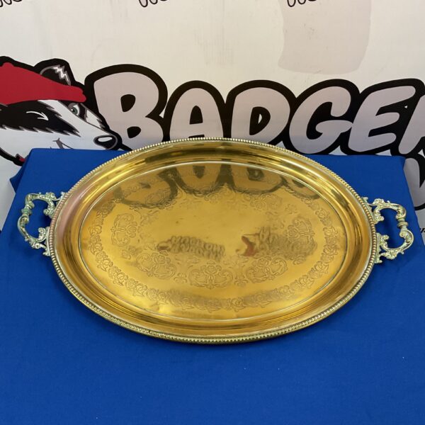 Ornate vintage brass serving tray with embossed floral design.