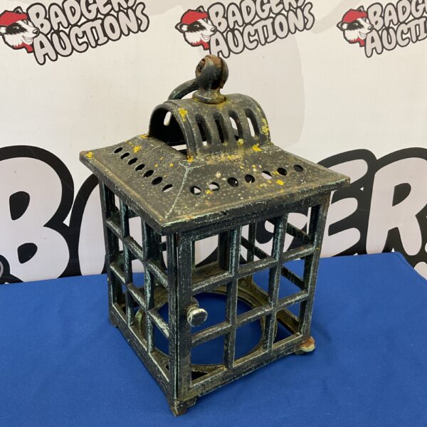 Vintage cast iron cage lantern with intricate metalwork.