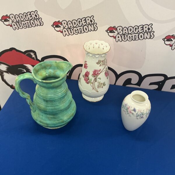 Vintage ceramic jug and vase set with floral design.