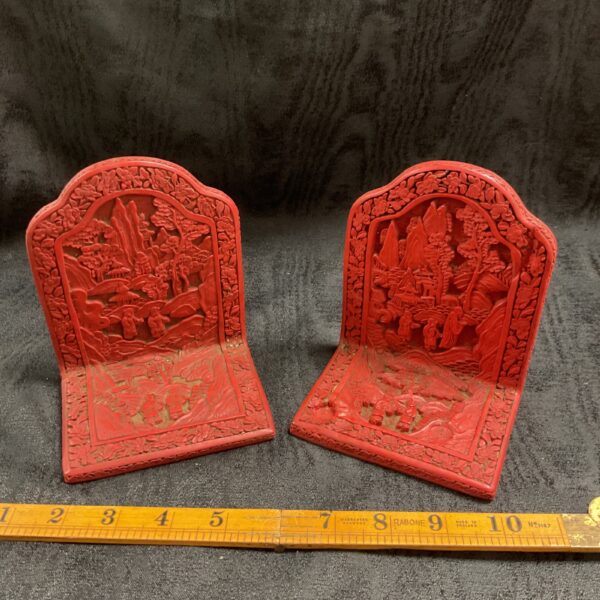 Pair of vintage Chinese cinnabar bookends with carved details.