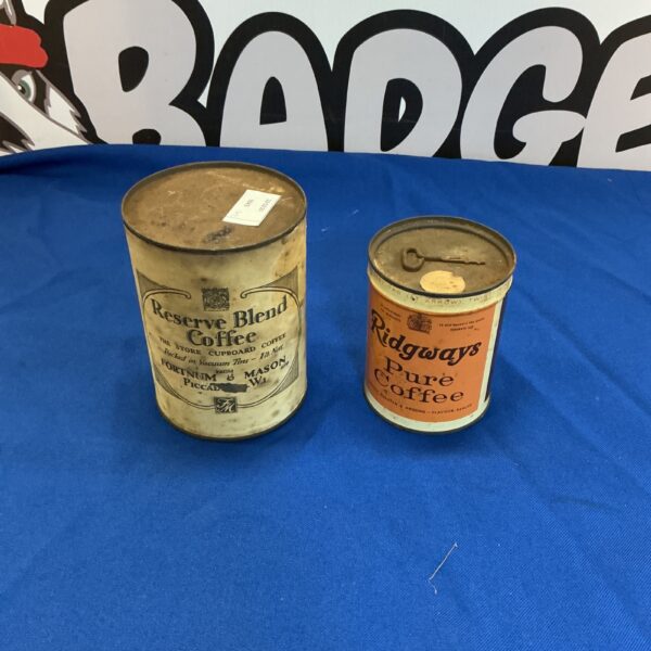 Pair of vintage coffee tins with colourful advertising.