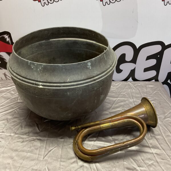 Vintage copper jardiniere and brass bugle horn on display.