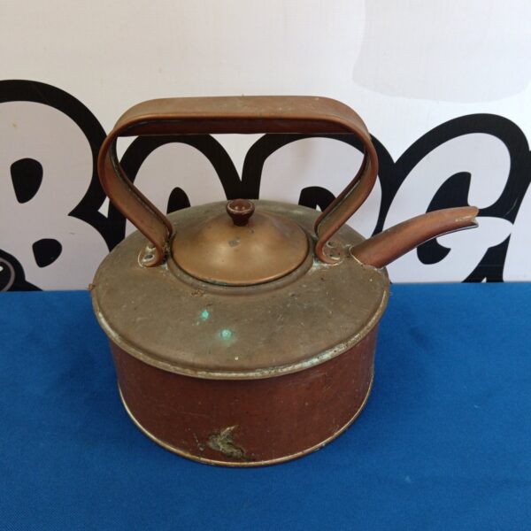 Vintage copper kettle with patina, a charming kitchen collectible.