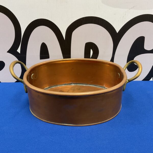 Vintage copper pan with sturdy brass handles, ideal for collectors.