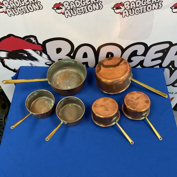 Lot of six vintage copper pans with brass handles.