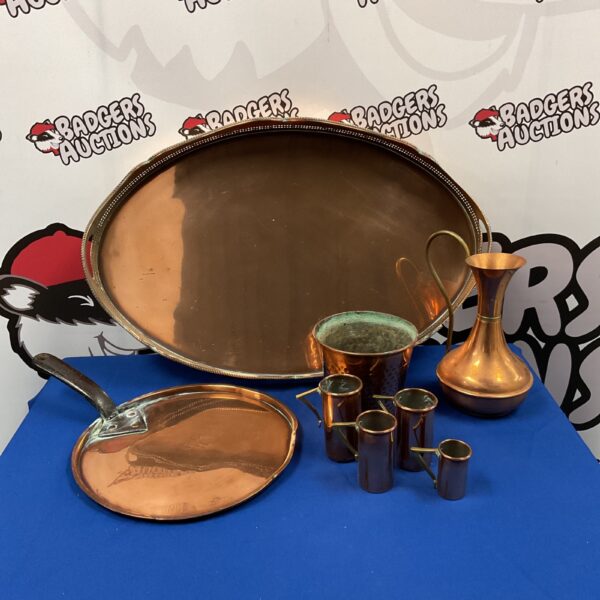 Vintage copper serving tray with barware set, including ewer and measures.