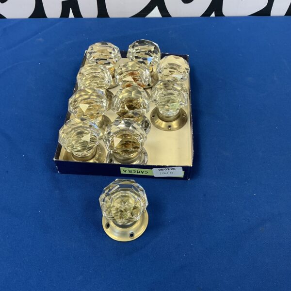 Set of vintage crystal door handles with brass bases.