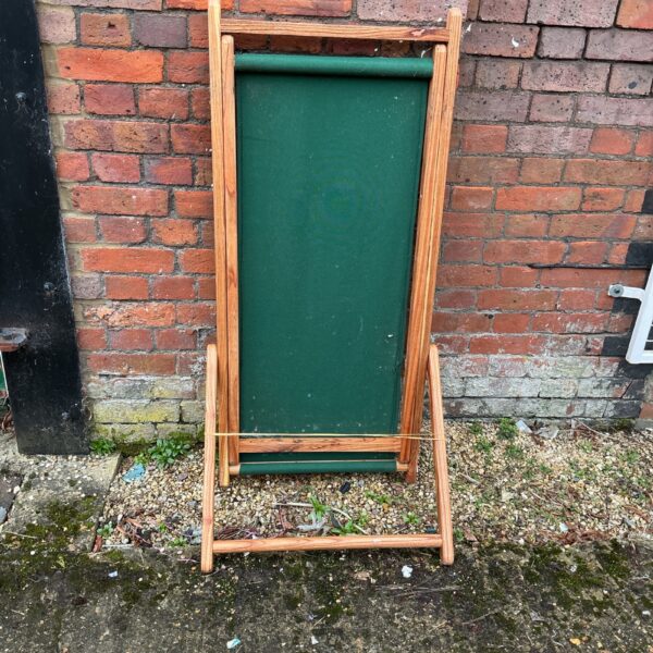Vintage wooden deck chair with canvas seat and back.