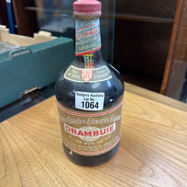 Vintage Drambuie bottle with label, Scottish whisky liqueur collectible.
