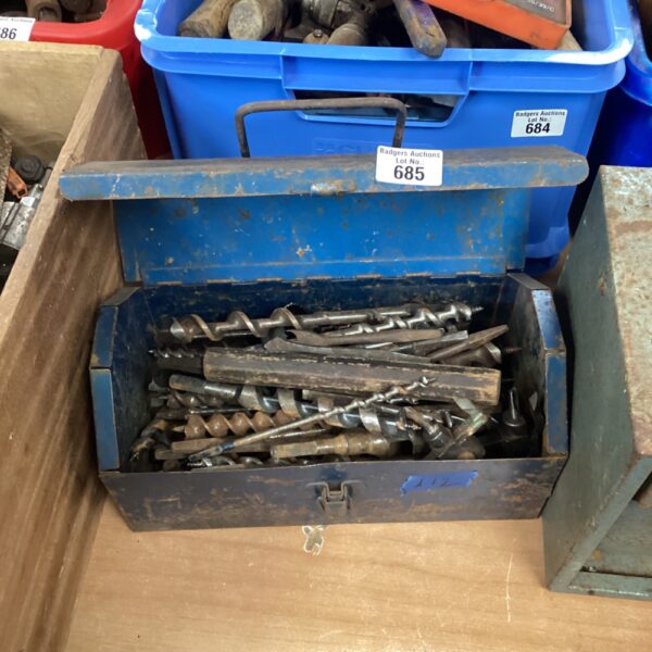Vintage blue metal toolbox filled with a variety of drill bits.
