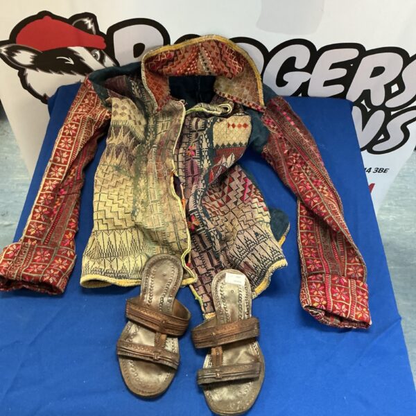 Vintage embroidered jacket and leather sandals, colourful folk art style.