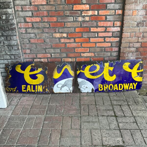 Large vintage enamel Broadway advertising sign with wear.