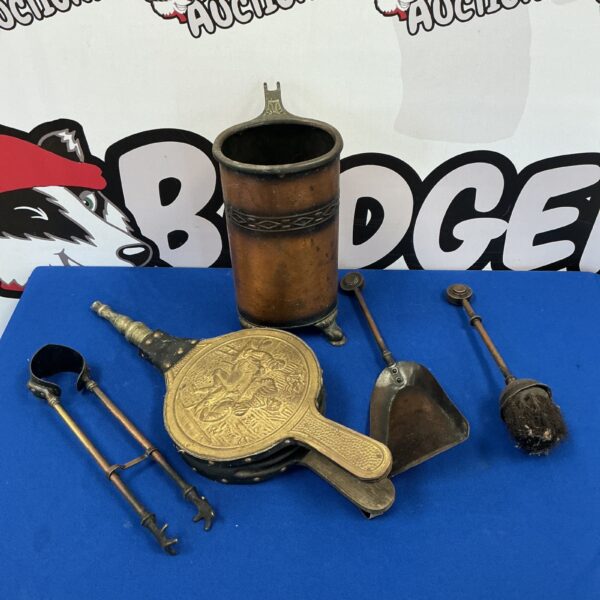 Vintage fireplace companion set with brass bellows and copper tools.