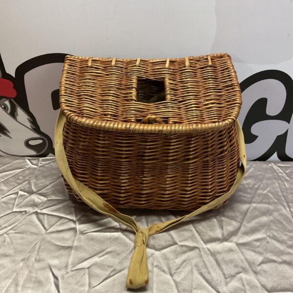 Vintage wicker fisherman’s basket with woven handle.