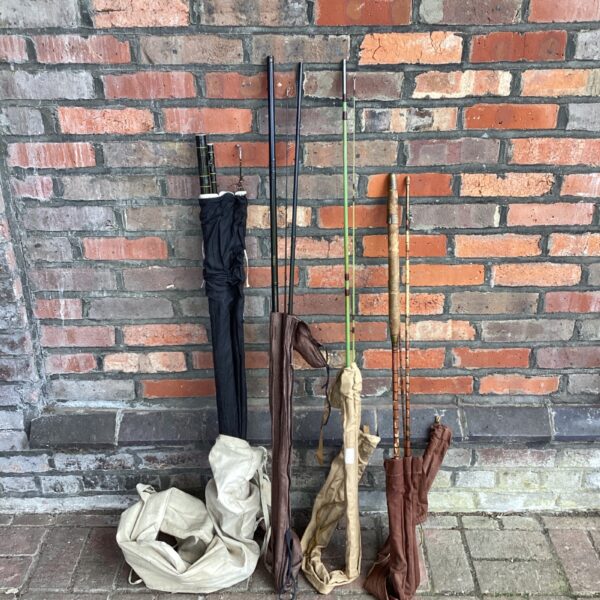 Lot of vintage fishing rods, including a Daiwa example.