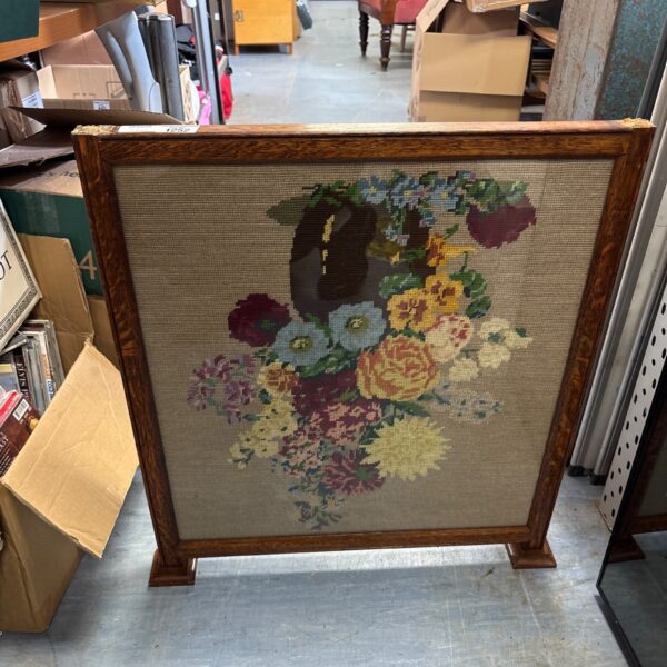 Vintage floral tapestry oak fireguard for hearth protection.