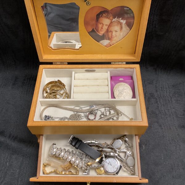 Vintage floral jewellery box filled with assorted jewellery pieces.