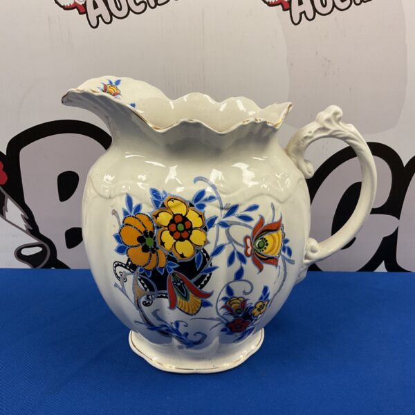 Vintage porcelain jug with a vibrant floral pattern for collectors.