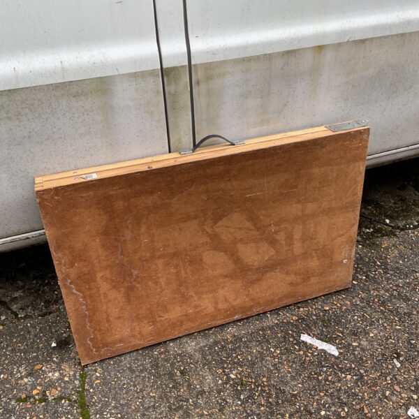 Vintage folding pasting table showing wear and tear.