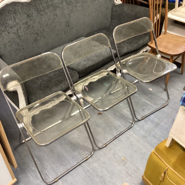 Vintage folding perspex chairs with chrome frames.