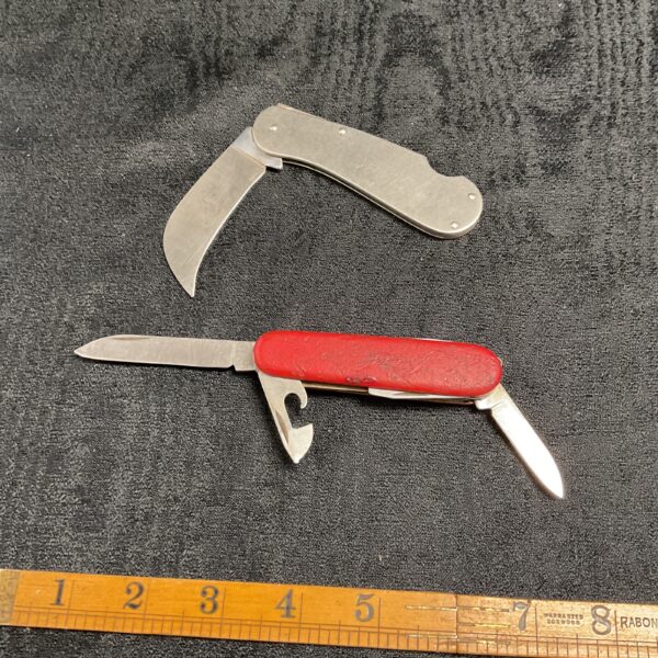 Vintage folding pruning knife with wooden handle and stainless steel blade.