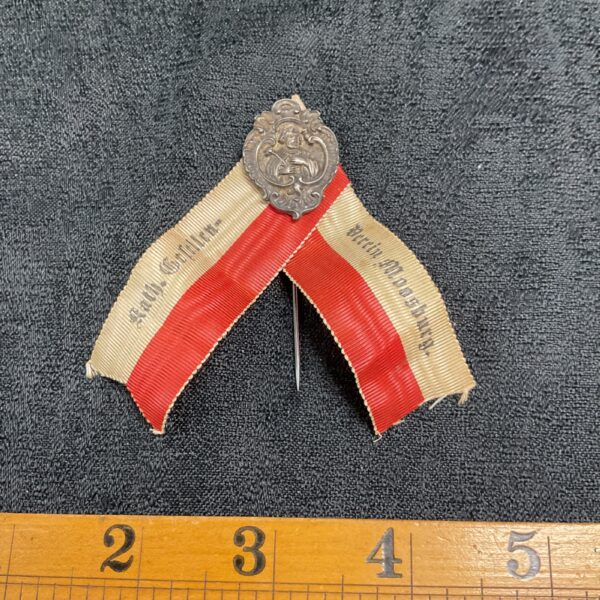 Vintage German lapel badge from Moosburgh, featuring a ribbon.