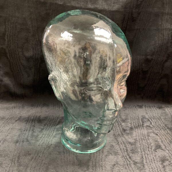 Clear vintage glass mannequin head for display.
