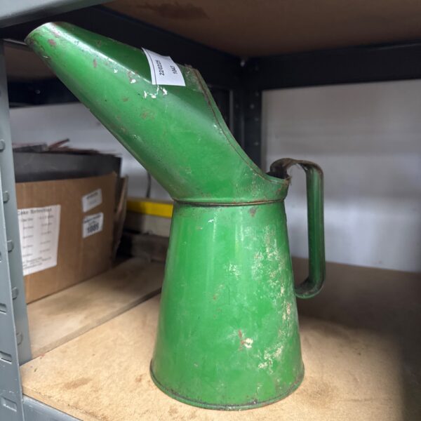 Vintage green metal oil can for lubrication.