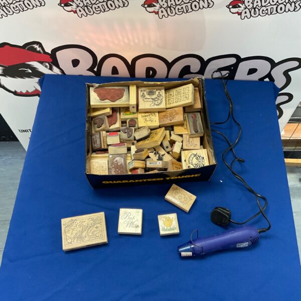 Vintage wooden block ink stamps and a heat gun for crafting.