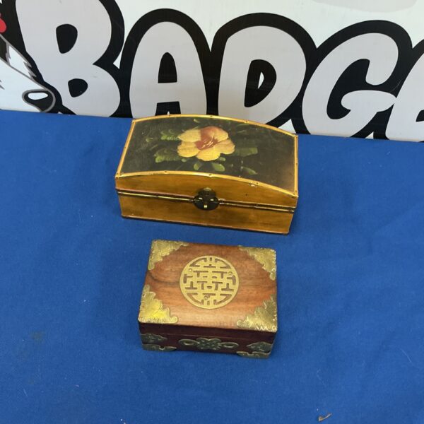 Two vintage wooden jewellery boxes with decorative detailing.