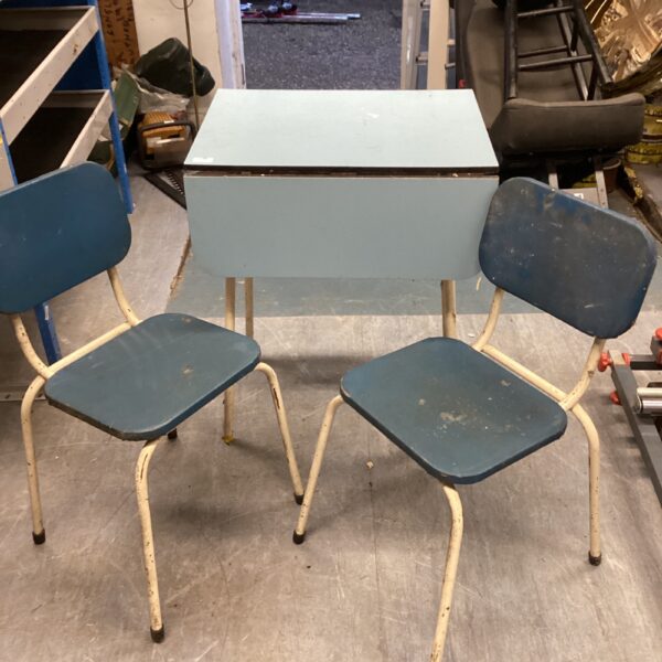 Vintage kitchen table and two chairs with metal legs.