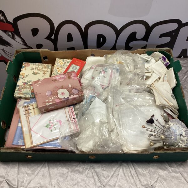 Vintage ladies lot with handkerchiefs and hat pins displayed.