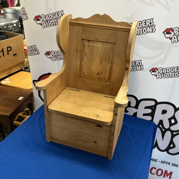 Vintage wooden lambing chair for assisting sheep birthing.