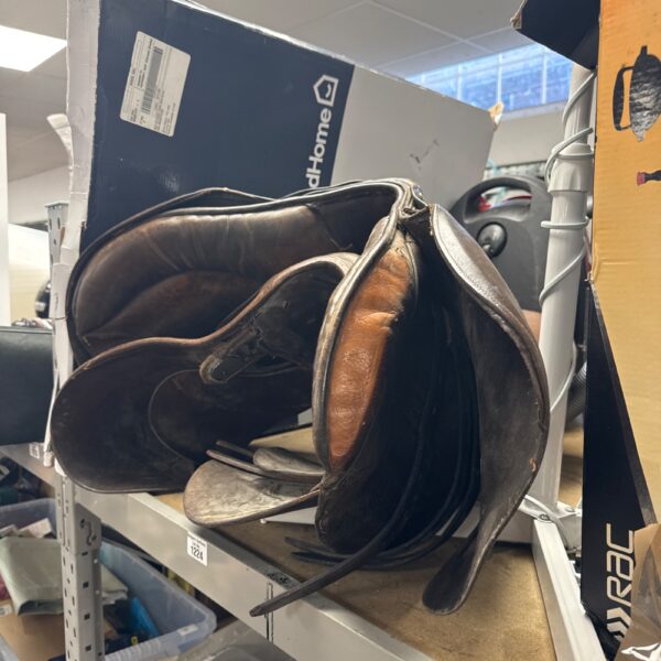 Two vintage leather horse saddles displayed in a lot.