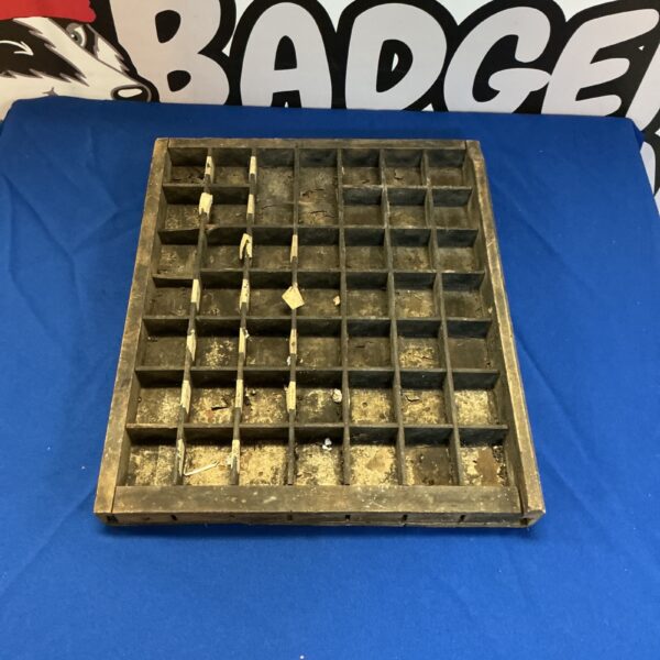 Vintage wooden letterpress tray with compartments for type.