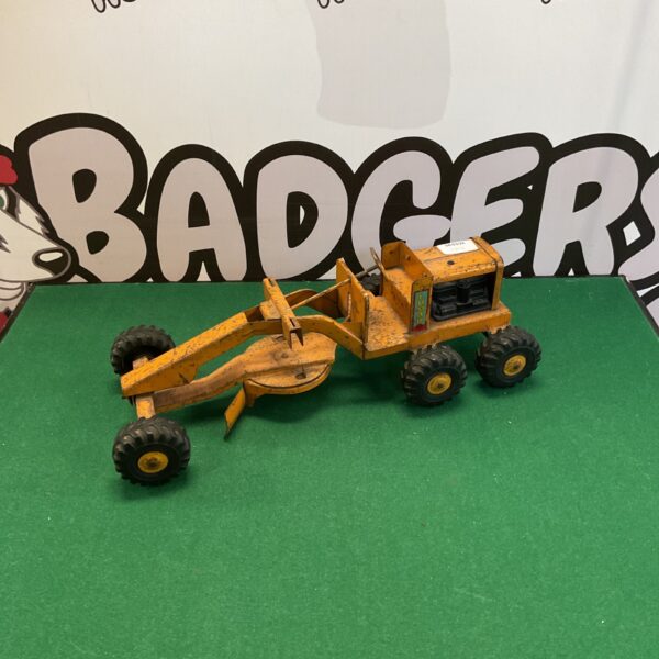 Vintage yellow Lumar ground grader toy for collectors.