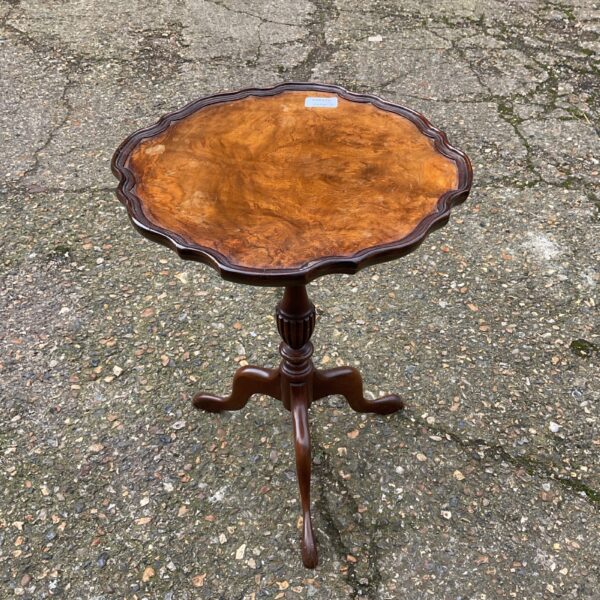 Vintage mahogany piecrust lamp table with curved legs.