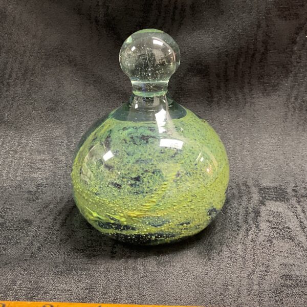 Vintage Mdina glass paperweight with swirling green and blue colours.