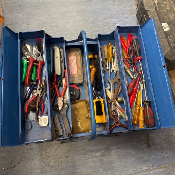 Vintage metal cantilever toolbox filled with various hand tools.