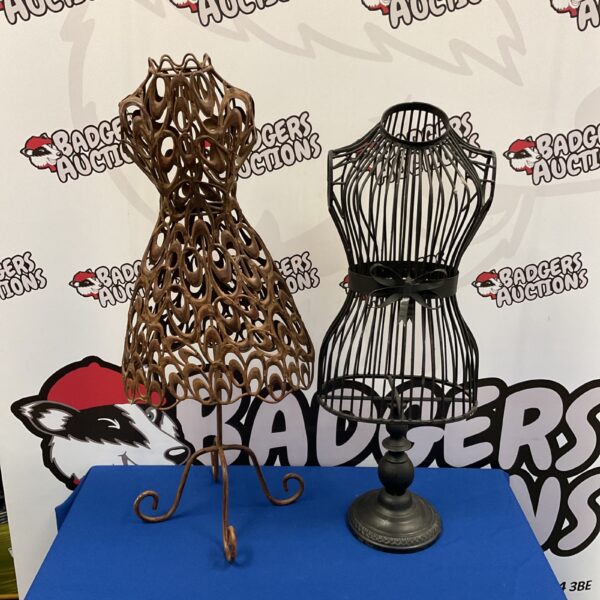 Vintage metal dressmaker mannequin with ornate design.