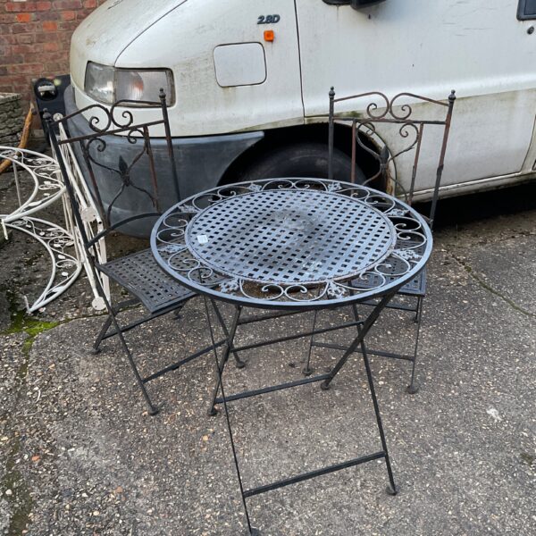 Vintage metal garden furniture set needing restoration.