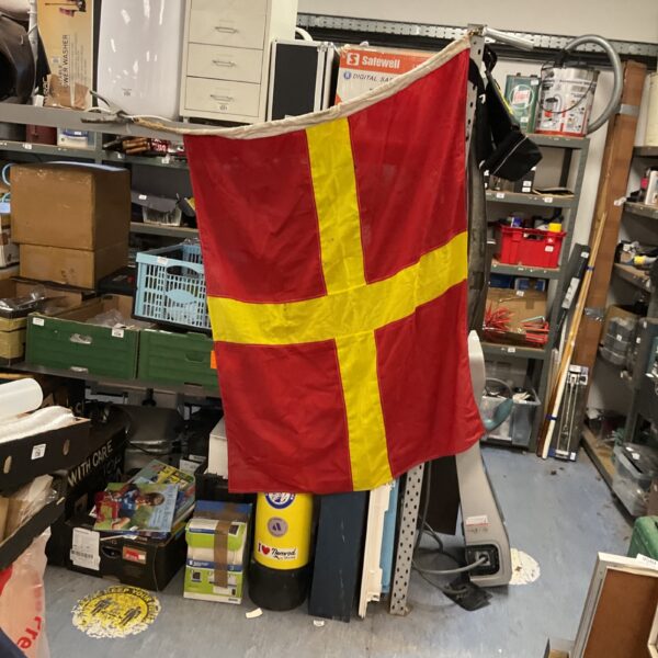 Vintage nautical signal flag displaying the letter R, a classic maritime collectible.