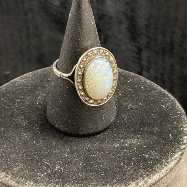 Close-up of vintage opal halo ring with markasite stones.