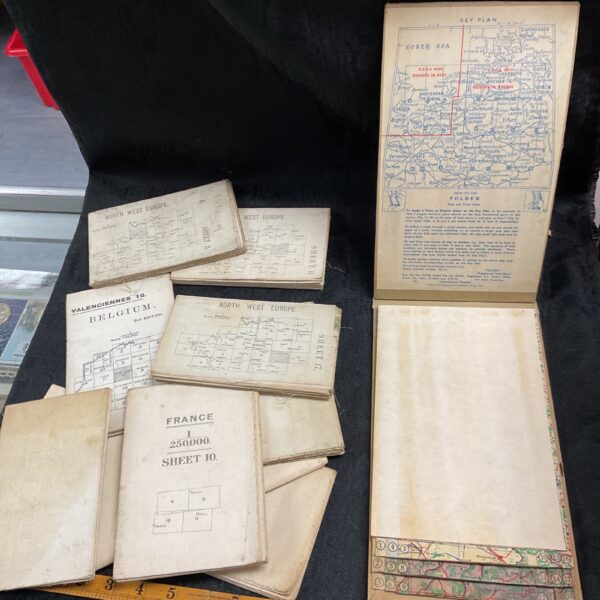 Collection of vintage Ordnance Survey maps and rulers.