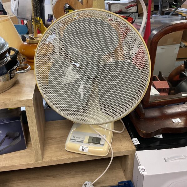 Cream coloured vintage oscillating fan for home use.