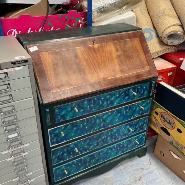 Vintage writing bureau with vibrant peacock feather design.