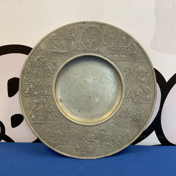 Vintage pewter plate with tradesman pattern, antique collectible.