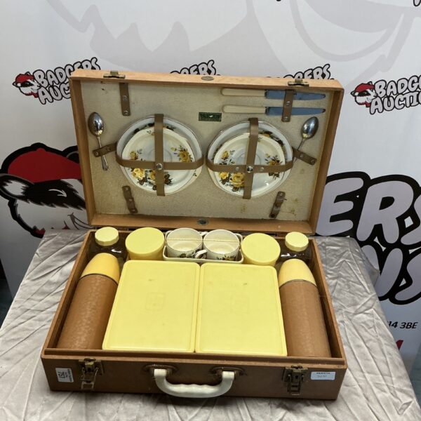 Open vintage Brixton picnic set with enamelware inside case.