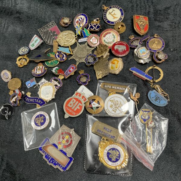 Large collection of vintage pin badges with diverse designs and themes.
