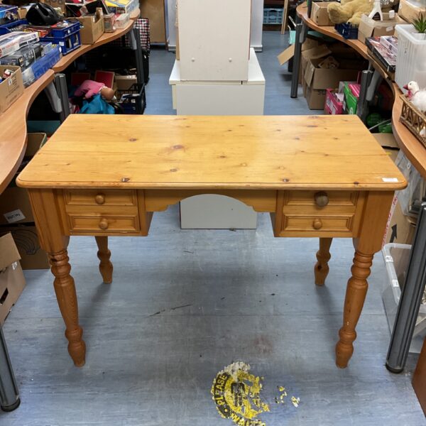 Vintage pine desk with four drawers, solid wood construction.